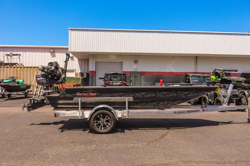 Slide: The Image of 2026 Gator Tail 17/50 MID DECK SAVAGE SERIES boat on trailer, parked outdoors. - 2