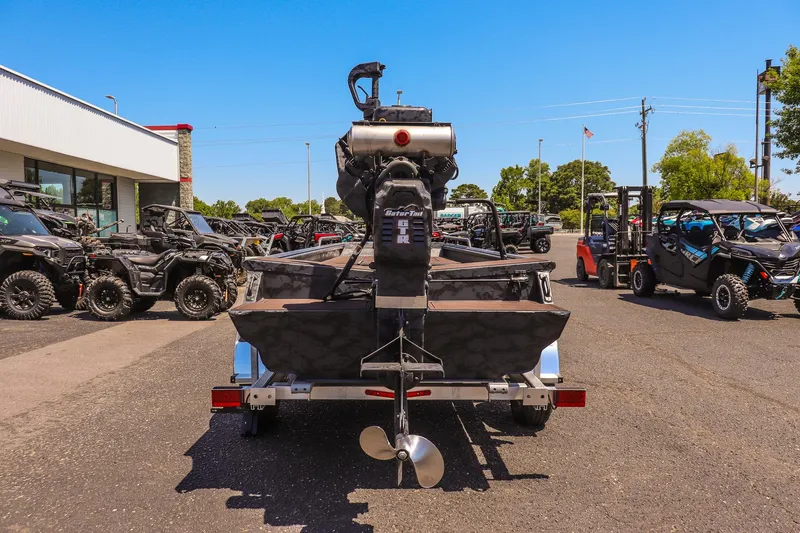 Slide: The Image of 2026 Gator Tail 17/50 MID DECK SAVAGE SERIES boat on trailer, surrounded by off-road vehicles. - 4