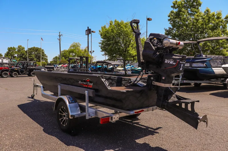 Slide: The Image of 2026 Gator Tail 17/50 Mid Deck Savage Series boat on trailer in outdoor lot. - 5