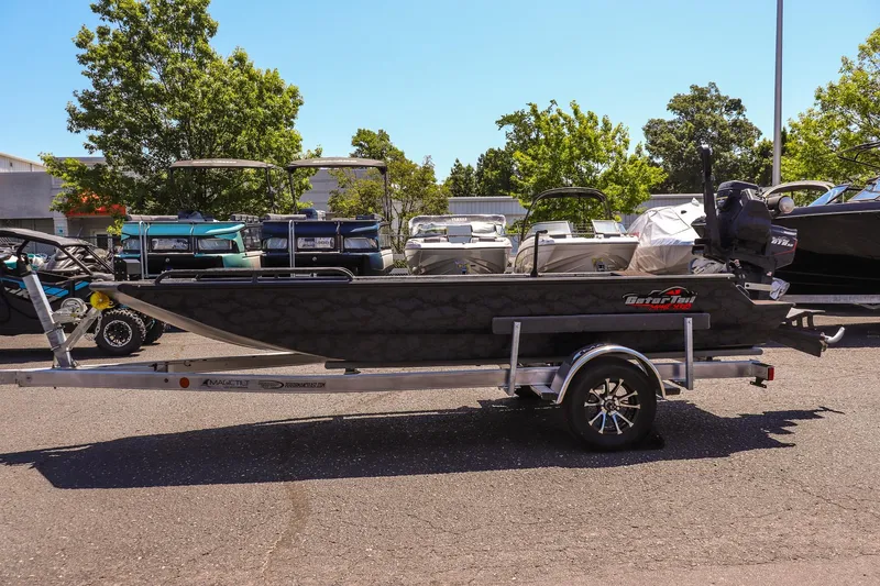Slide: The Image of 2026 Gator Tail 17/50 MID DECK SAVAGE SERIES boat on trailer, parked outdoors. - 6