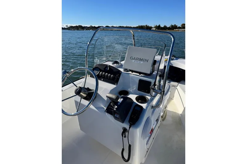 Slide: The Image of 2006 Boston Whaler 170 Montauk boat console with Garmin GPS on calm water. - 2