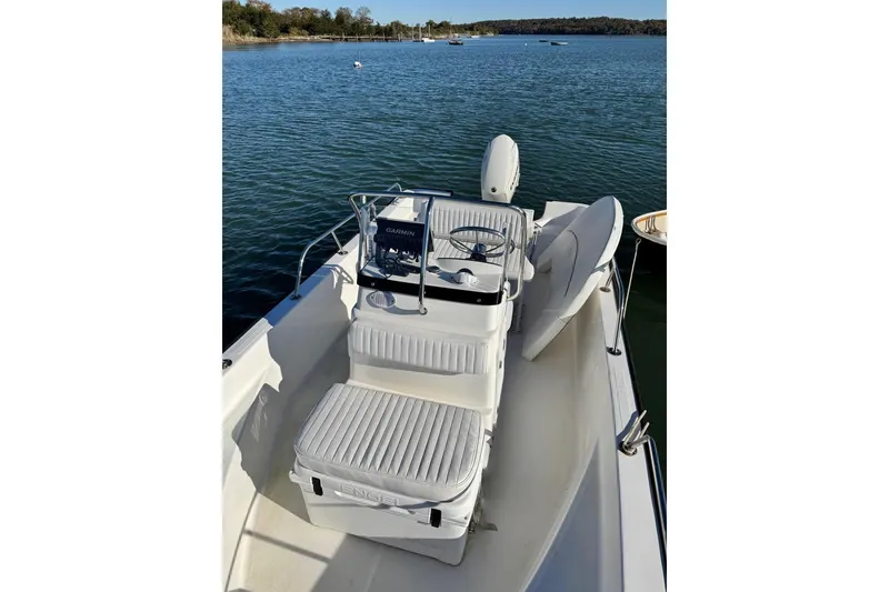 Slide: The Image of 2006 Boston Whaler 170 Montauk boat on calm water, featuring a Garmin navigation system. - 3