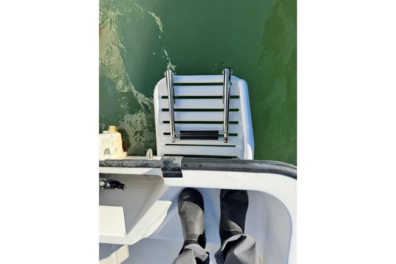 Slide: The Image of Boston Whaler 170 Montauk 2006 boat ladder and deck view over water. - 5