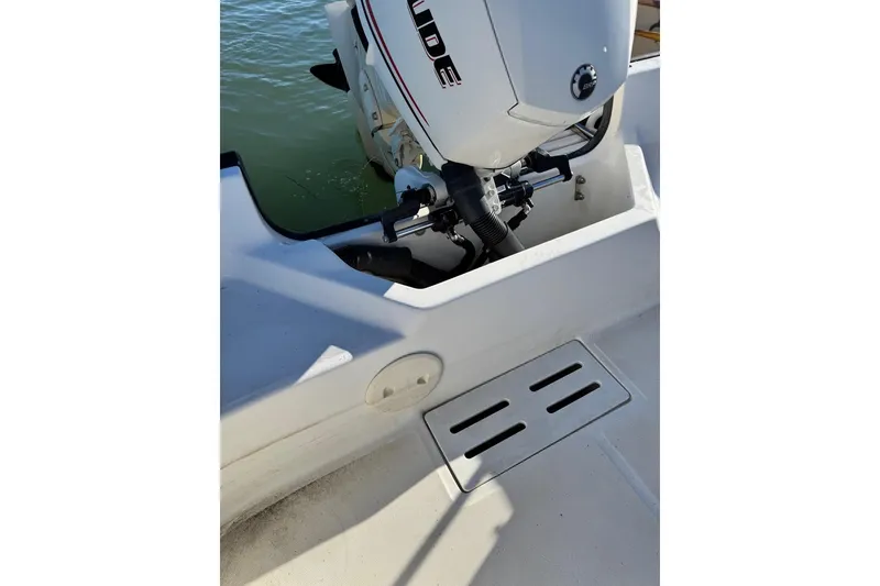 Slide: The Image of 2006 Boston Whaler 170 Montauk boat with outboard motor on calm water. - 6