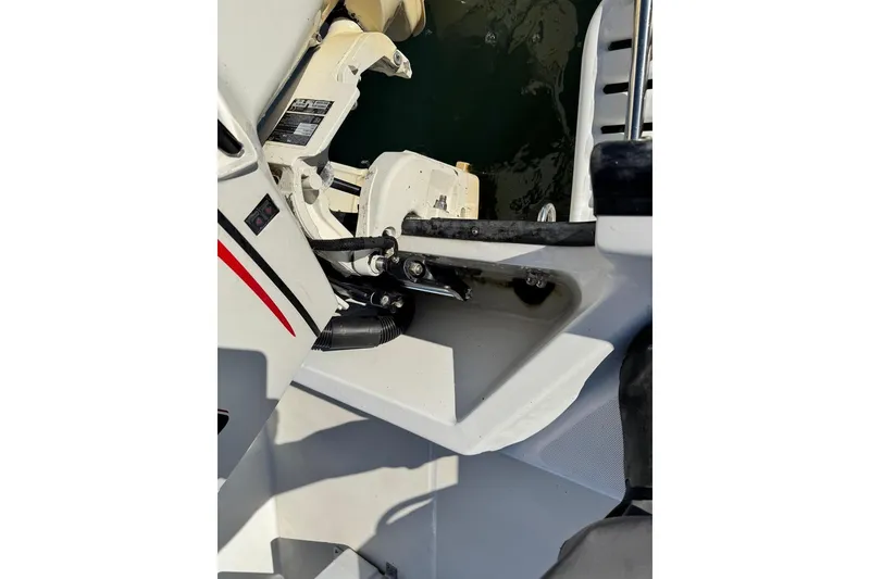 Slide: The Image of Boston Whaler 170 Montauk 2006 boat engine detail near water. - 8