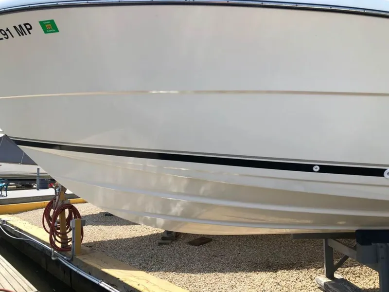 Slide: The Image of 2004 Pursuit 3070 Offshore boat on a dock. - 10