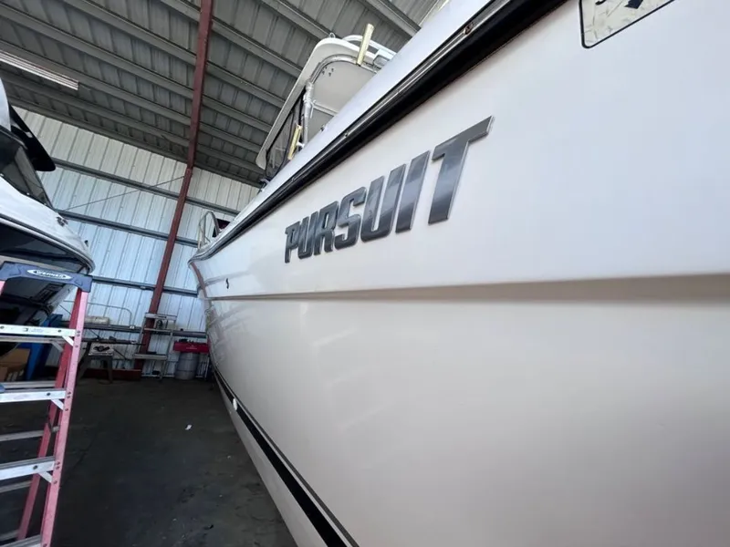 Slide: The Image of Close-up of a 2004 Pursuit 3070 Offshore boat in a storage facility. - 11
