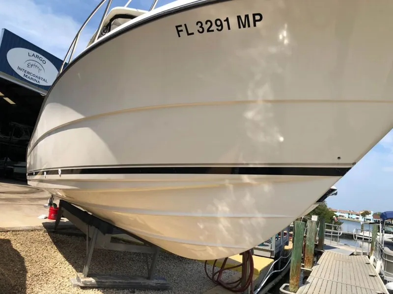 Slide: The Image of 2004 Pursuit 3070 Offshore boat at marina, side view. - 12