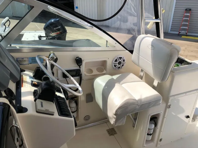Slide: The Image of Interior of a 2004 Pursuit 3070 Offshore boat with helm console. - 16