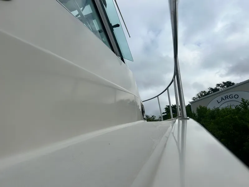 Slide: The Image of Close-up of a 2004 Pursuit 3070 Offshore yacht under cloudy skies. - 5