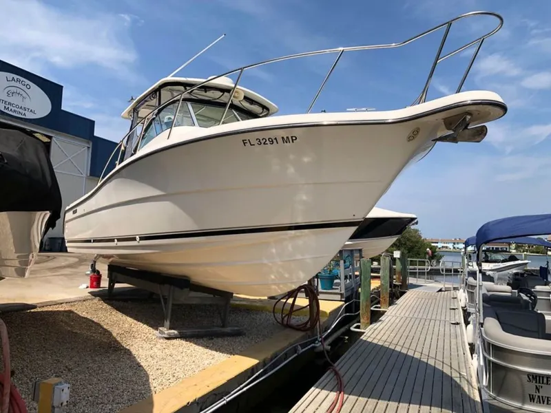 Slide: The Image of 2004 Pursuit 3070 Offshore boat docked at marina. - 8