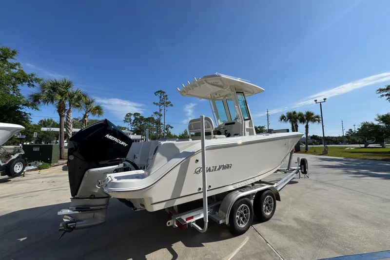 Slide: The Image of 2026 Sailfish 232 CC boat on trailer, featuring Mercury outboard motor, parked outdoors. - 10