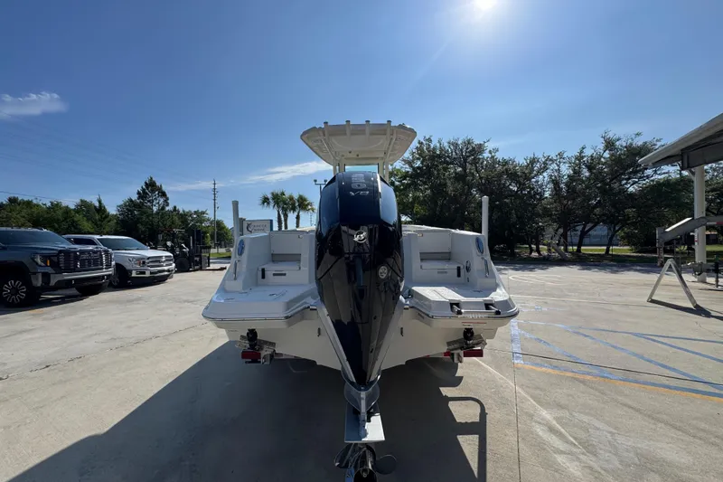Slide: The Image of 2026 Sailfish 232 CC boat with outboard motor in a sunny outdoor setting. - 12