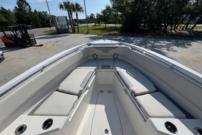 Slide: The Image of 2026 Sailfish 232 CC boat interior with cushioned seating and cup holders. - 16