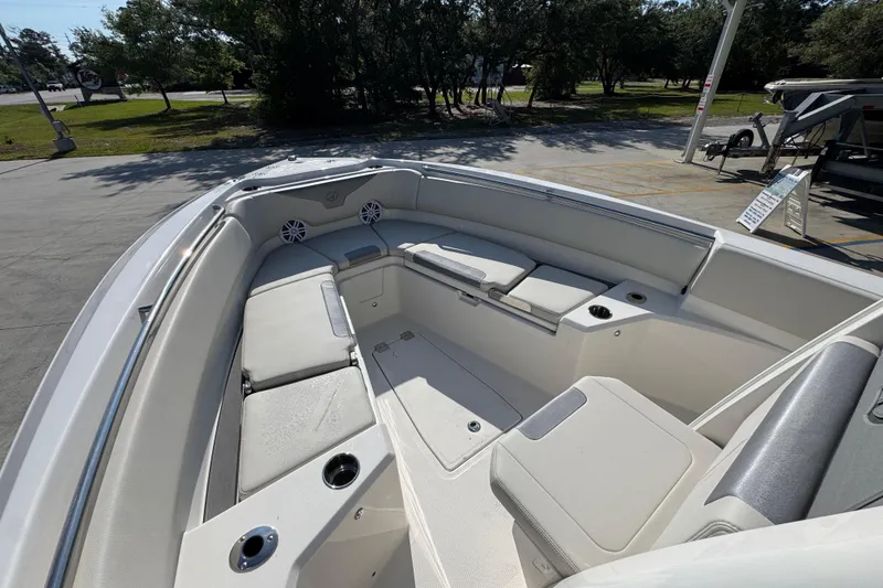 Slide: The Image of 2026 Sailfish 232 CC boat interior with cushioned seating and cup holders. - 17