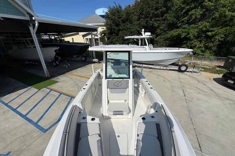 Slide: The Image of 2026 Sailfish 232 CC boat displayed in a marina with other vessels. - 19