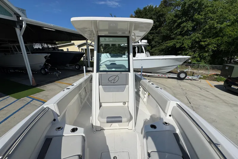 Slide: The Image of 2026 Sailfish 232 CC boat interior view at a marina, showcasing seating and console. - 20