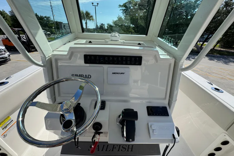 Slide: The Image of 2026 Sailfish 232 CC boat dashboard with steering wheel and control panel. - 28