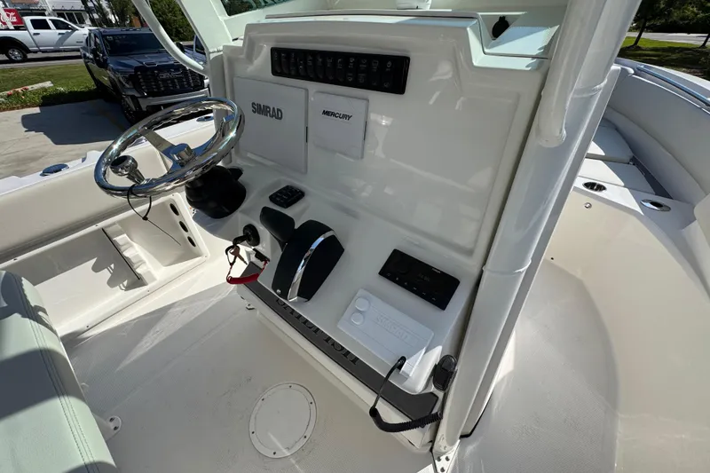 Slide: The Image of 2026 Sailfish 232 CC boat console with steering wheel and control panel. - 29