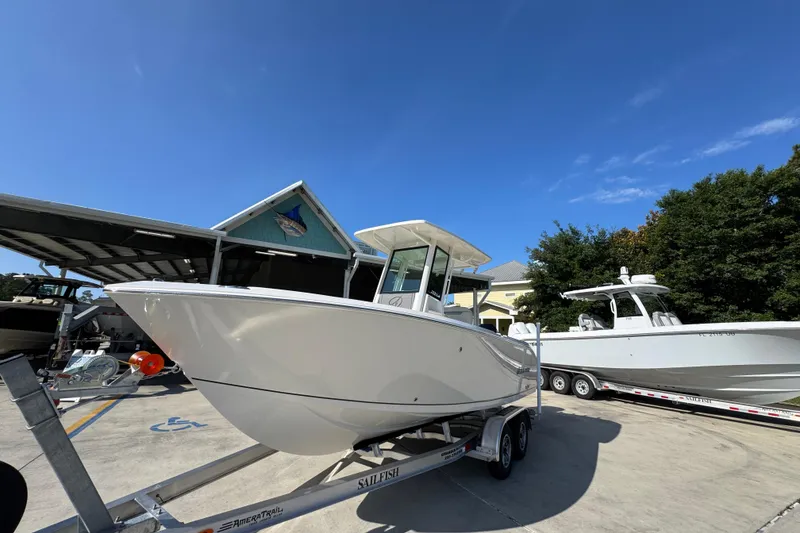 Slide: The Image of 2026 Sailfish 232 CC boat on trailer under clear blue sky. - 3