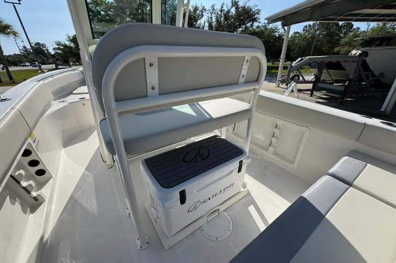 Slide: The Image of 2026 Sailfish 232 CC boat interior with seating and storage cooler. - 31