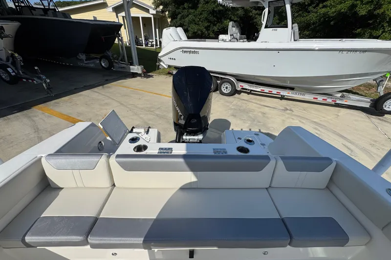 Slide: The Image of 2026 Sailfish 232 CC boat interior with seating and motor, parked on a trailer. - 34
