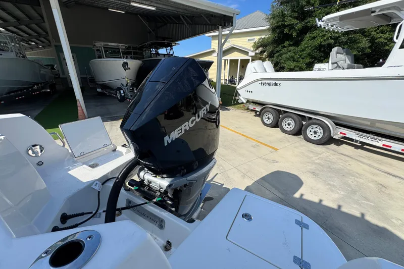 Slide: The Image of 2026 Sailfish 232 CC boat with Mercury engine in a marina setting. - 37