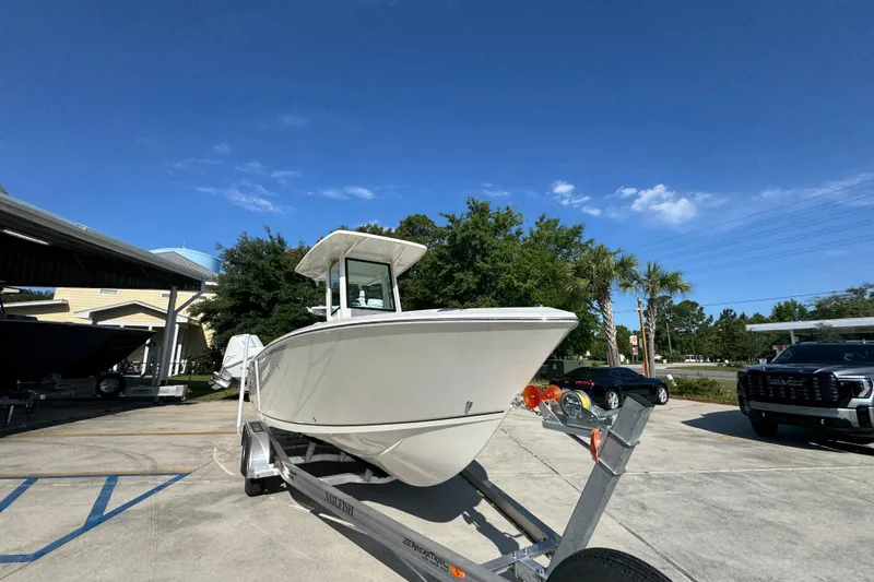 Slide: The Image of 2026 Sailfish 232 CC boat on trailer under clear blue sky. - 6