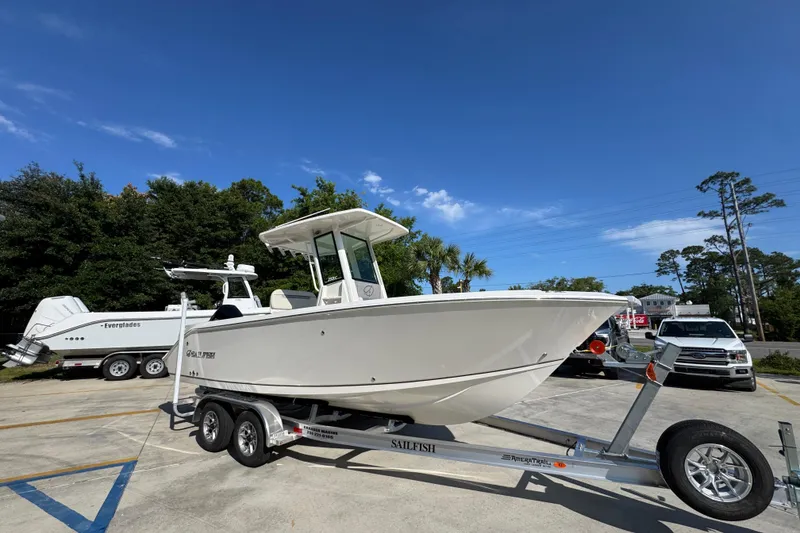 Slide: The Image of 2026 Sailfish 232 CC boat on trailer under clear blue sky. - 7