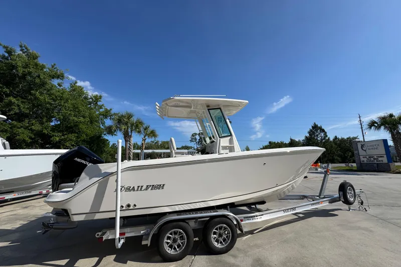 Slide: The Image of 2026 Sailfish 232 CC boat on trailer under clear blue sky. - 9