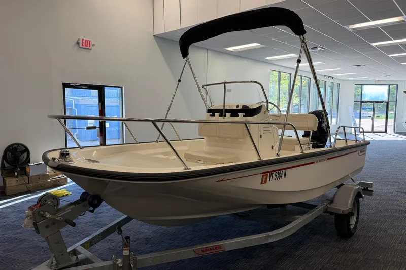 The Image of 2021 Boston Whaler 150 Montauk boat on trailer in showroom setting. - 0