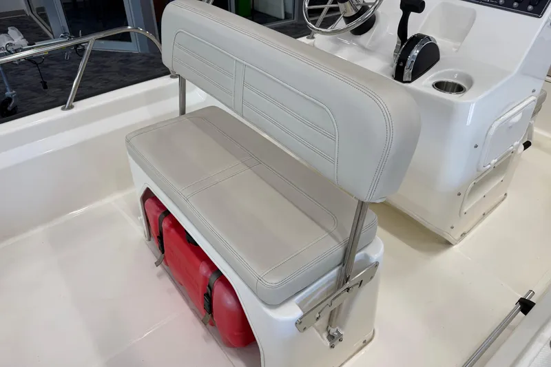 Slide: The Image of 2021 Boston Whaler 150 Montauk interior with seating and steering console. - 10