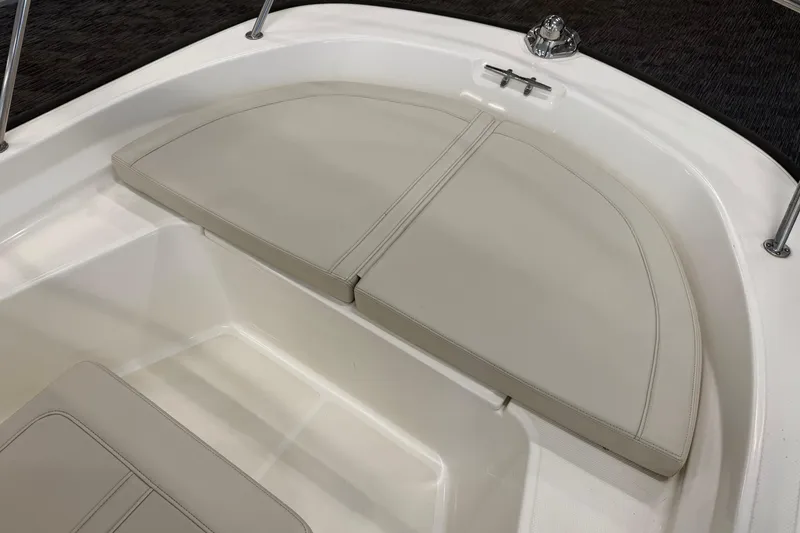 Slide: The Image of 2021 Boston Whaler 150 Montauk boat interior with cushioned seating area. - 14
