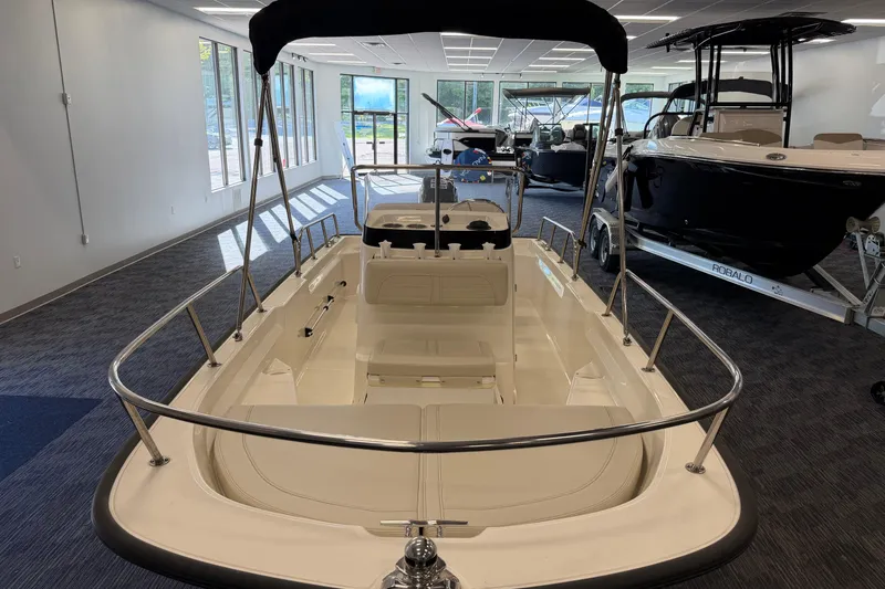 Slide: The Image of 2021 Boston Whaler 150 Montauk boat displayed in a showroom with other boats. - 6