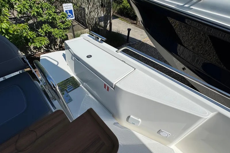 Slide: The Image of Nimbus Commuter 11 boat, 2025, with seating area and reserved parking sign. - 10