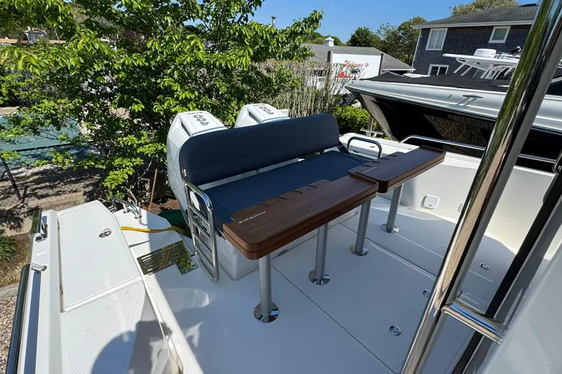 Slide: The Image of Nimbus Commuter 11 boat 2025 with seating area and engines. - 12