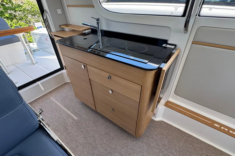 Slide: The Image of Interior of Nimbus Commuter 11, 2025, featuring modern kitchenette. - 17
