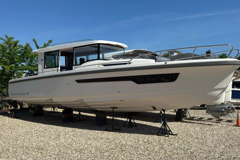 Slide: The Image of Nimbus Commuter 11 boat 2025 displayed on gravel surface. - 2