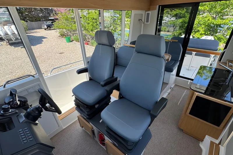 Slide: The Image of Interior of Nimbus Commuter 11 boat, 2025 model, featuring modern seating. - 26