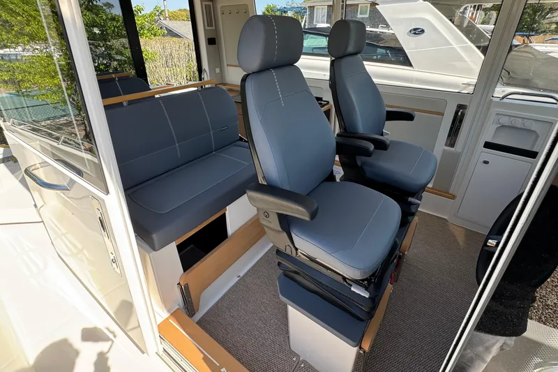 Slide: The Image of Interior of Nimbus Commuter 11 boat, 2025 model, featuring blue seats. - 28