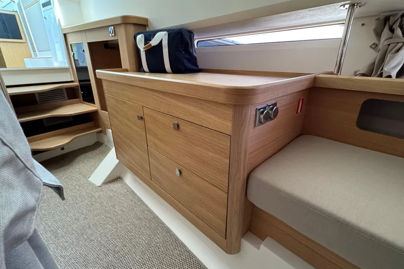 Slide: The Image of Interior of Nimbus Commuter 11, 2025, featuring wooden cabinets and seating area. - 34