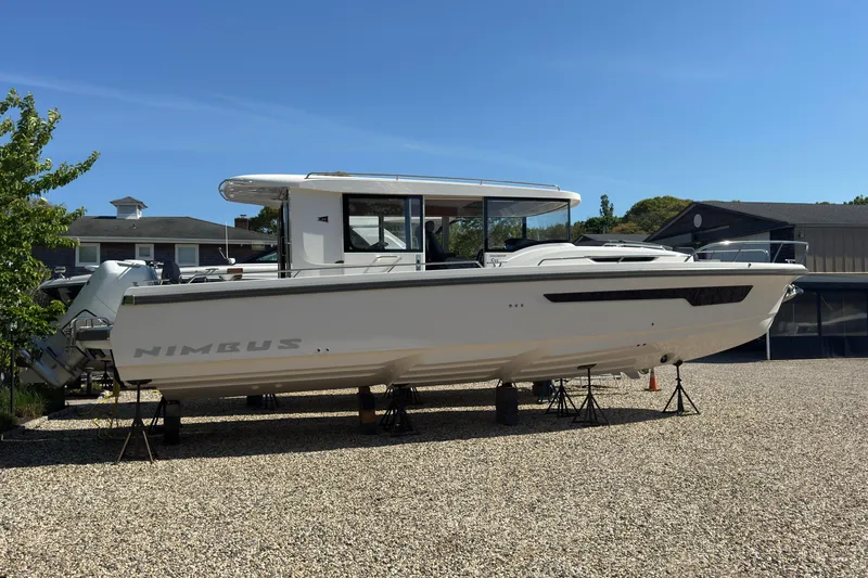 Slide: The Image of Nimbus Commuter 11 boat 2025 displayed on gravel lot. - 5