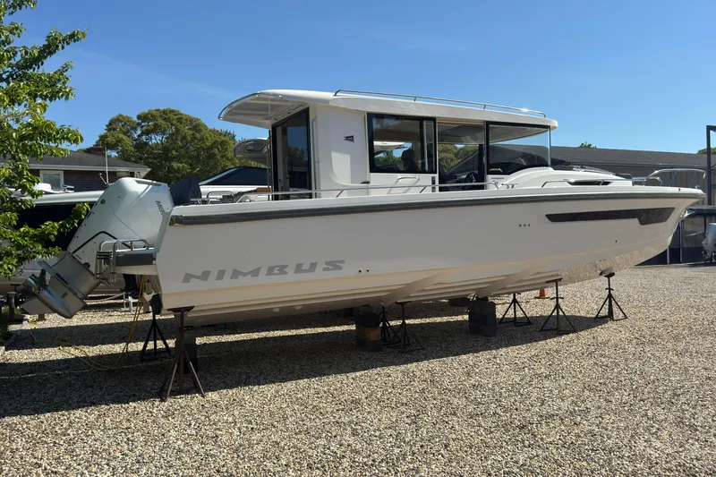 Slide: The Image of Nimbus Commuter 11 boat 2025 displayed on gravel lot. - 6
