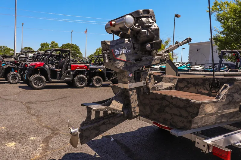 Slide: The Image of 2026 Gator Tail 17/50 MID DECK SAVAGE SERIES boat with camo design, parked outdoors. - 12