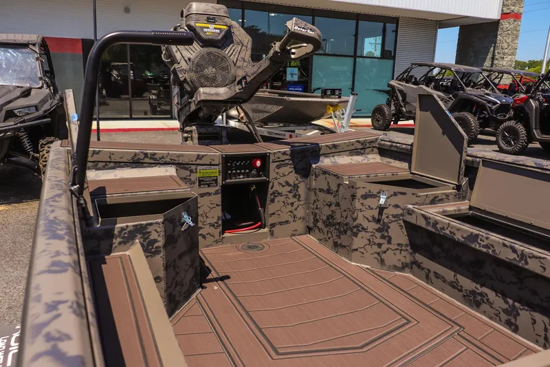 Slide: The Image of 2026 Gator Tail 17/50 MID DECK SAVAGE SERIES boat with camo design and open storage compartments. - 13