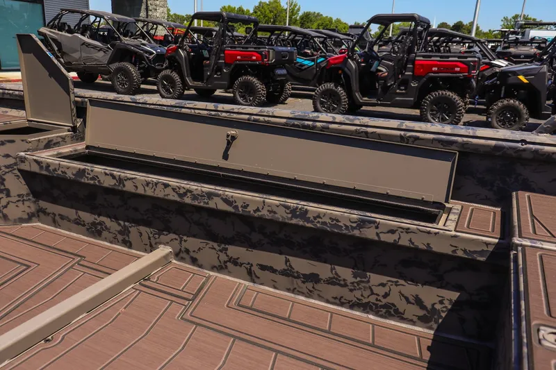 Slide: The Image of 2026 Gator Tail 17/50 MID DECK SAVAGE SERIES boat interior with storage compartment open. - 14
