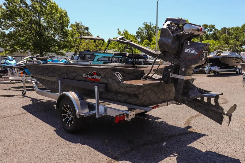 Slide: The Image of 2026 Gator Tail 17/50 MID DECK SAVAGE SERIES boat on trailer, parked outdoors. - 5