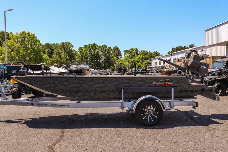 Slide: The Image of 2026 Gator Tail 17/50 MID DECK SAVAGE SERIES boat on trailer, parked outdoors. - 6