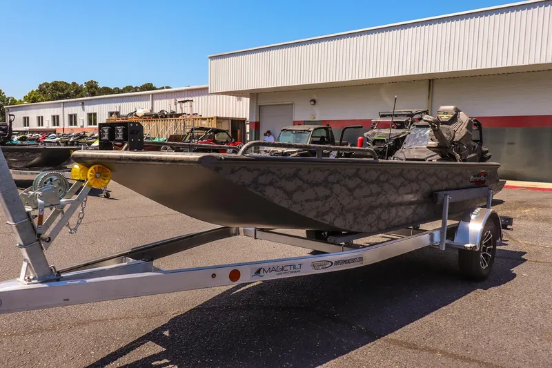 Slide: The Image of 2026 Gator Tail 17/50 MID DECK SAVAGE SERIES boat on trailer, parked outdoors. - 7