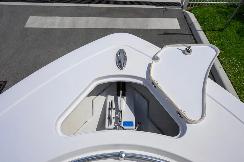 Slide: The Image of 2023 Sportsman Open 302 Center Console boat anchor compartment, open lid view. - 12